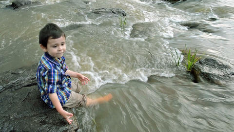 Child having fun at the riverside