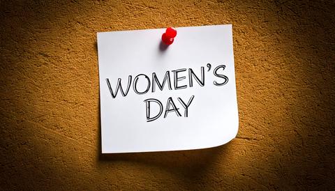 Womans day concept; text on paper pinned at the wall