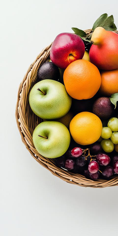 Vibrant Assortment of Fresh Fruits in a Woven Basket on a White Background