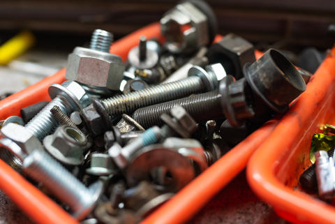 different types of screws in a plastic box