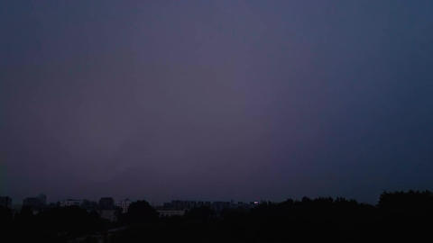 Bright lightning in dark night sky. Thunderstorm over the city