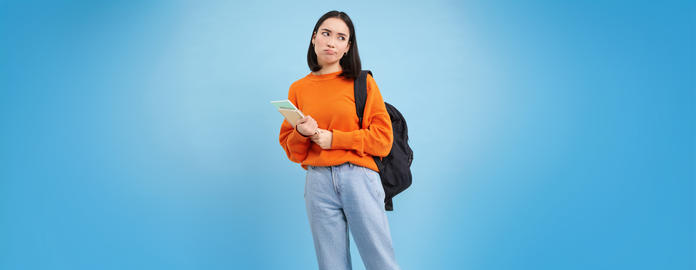 Bored college student, girl with backpack and notebooks, sulks and rolls eyes, stands upset against