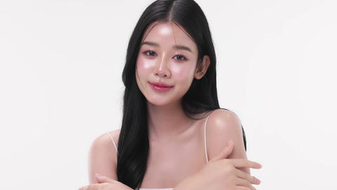 Close up portrait beautiful young Asian woman with healthy facial glass skin over white background
