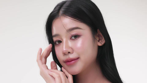 Close up portrait beautiful young Asian woman with healthy facial glass skin over white background