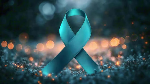 Teal awareness ribbon glowing with bokeh light on bed of flowers and soft moss