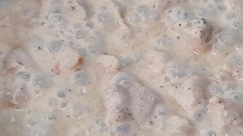Meat is stewed in sauce in pan