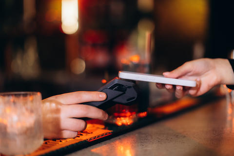 Contactless Mobile Payment in Action at a Stylish Modern Bar