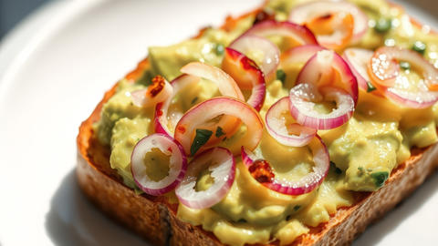 Avocado Toast Topped with Pickled Red Onions and Herbs