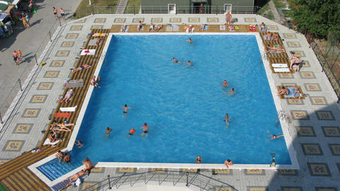 Large pool with many people in it