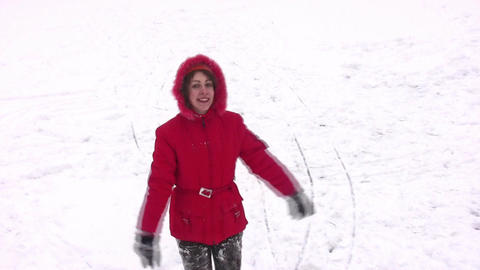 Woman in red coat stands snowy field