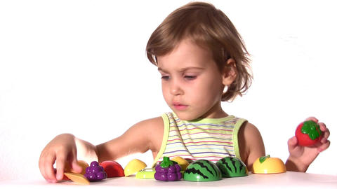Child engages with toy food set
