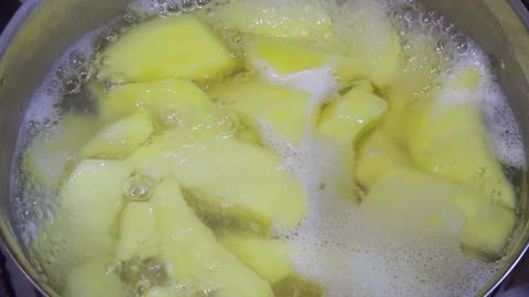 Potatoes boiling in a pot with bubbling water, creating an aromatic and homely