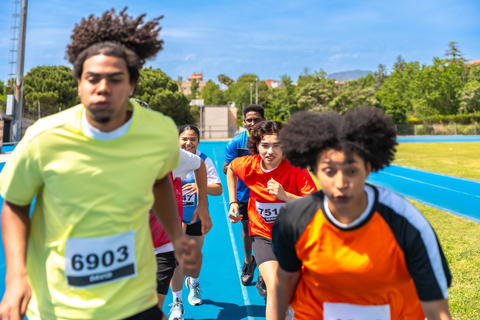 Determined athletes running on track during competition
