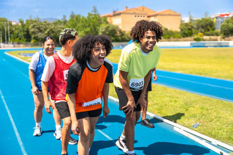 Runners recovering after finishing race on track