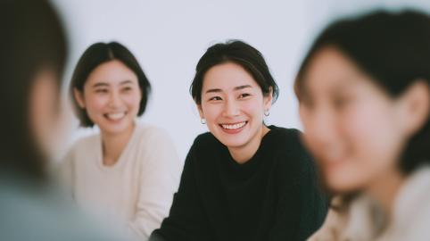 Three Women Smiling in Group Meeting, Friendship and Positive Communication