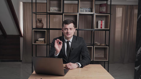 Male in dark suit looking at camera and emotional talking