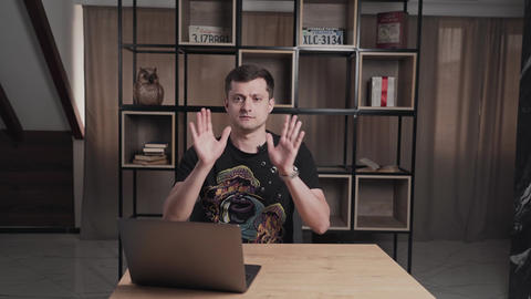Man is sitting at a table with laptop