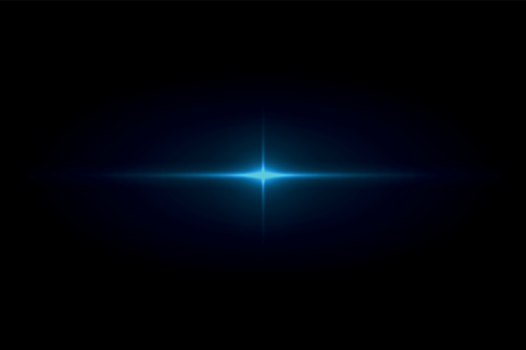 Blue glowing star light flare in dark background