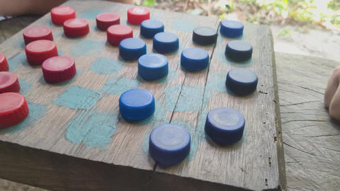 Close-up of a hand playing a rustic game of checkers usi GIF 48147651 ...