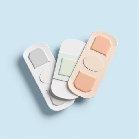 Three dimensional bandages in a soft pastel palette symbolizing medical care healing and comfort