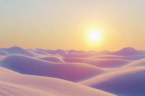 Sunrise over golden sand dunes in the desert creates a breathtaking view of
