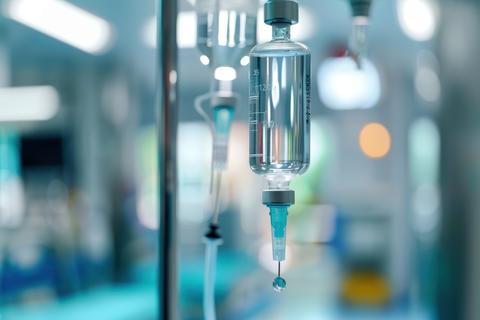 Close-up of an IV drip hanging in a hospital setting during nigh