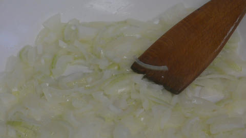 Food preparation. Passionating onions in a pan