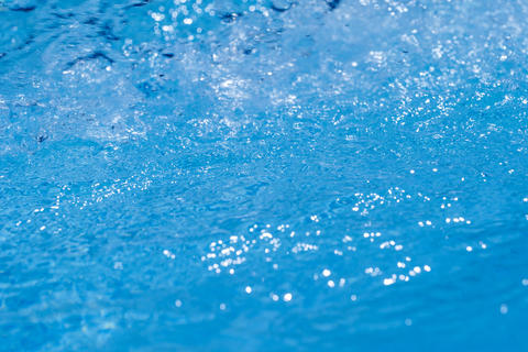Gentle Rolling Waves and Sparkling Water Surface Under the Bright Blue Sky Above