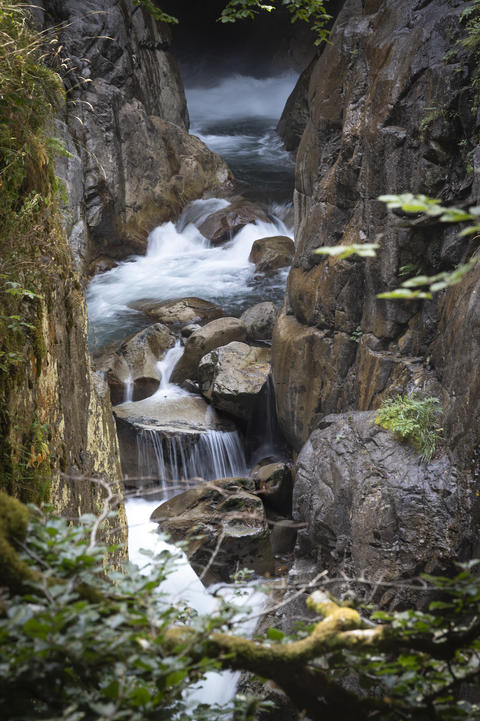 Flowing water cascades through rocky terrain in the Pyrenees near Cauteret