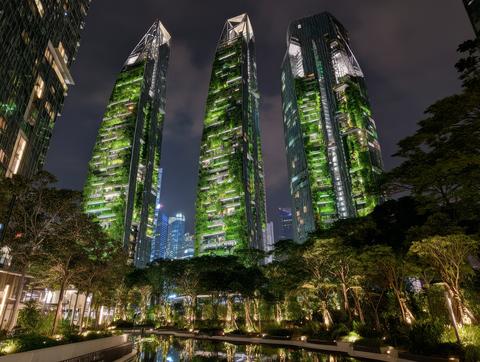 Night view of green vertical garden towers