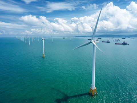 Aerial view of offshore wind turbines over sea