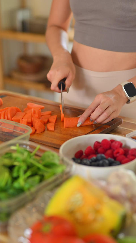 Homemade meal prep process showing hands cutting vegetables with fruits and