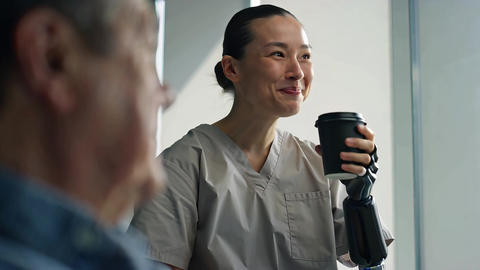 Hospital Patient's Prosthetic Arm holding Coffee Cup Amputee Disability Rehabilitation Bionic Tech