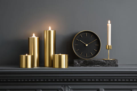 Arrangement of candles and marble clock. Concept of modern interior design