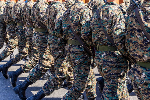 Soldiers marching in camouflage uniforms at military parade