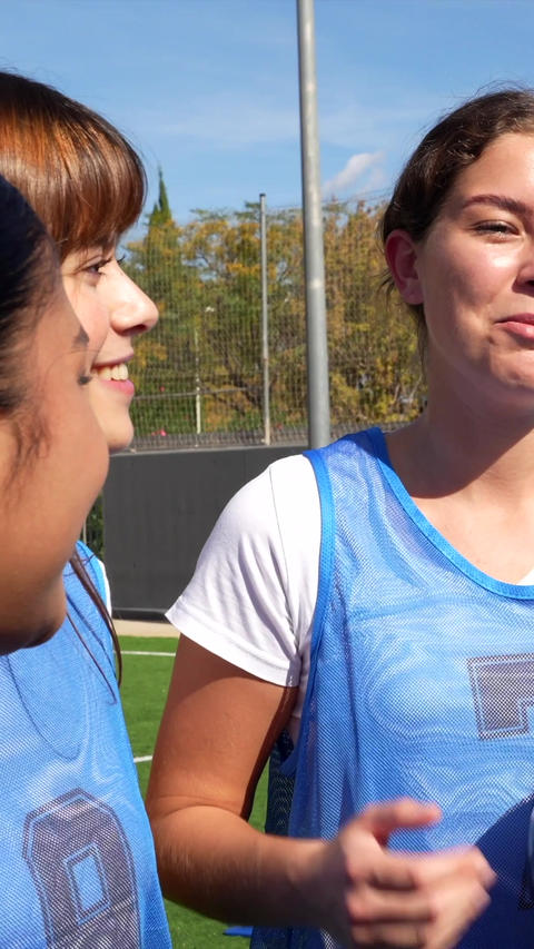 Group of happy female soccer players talking together before a match