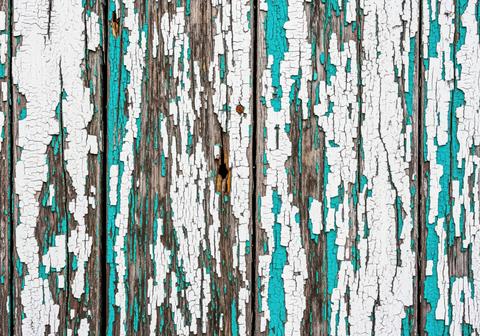 Distressed wood texture background with vertical planks and peeling white and teal paint