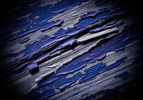 Peeling indigo blue paint texture on old weathered wood surface background