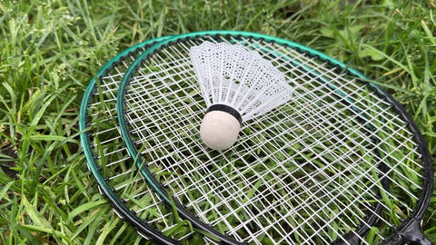 badminton equipment against a grassy background