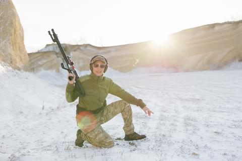 Soldier training with rifle in winter shooting range