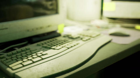 Old computer setup with keyboard and mouse on a work desk