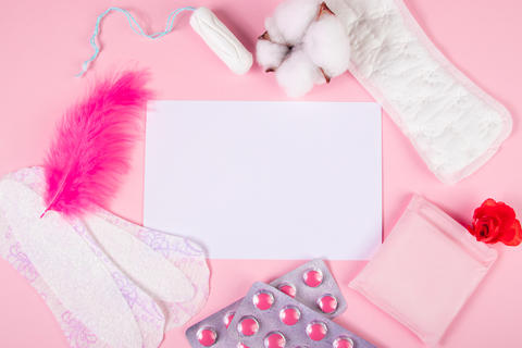 Set of feminine hygiene products for menstruation. Sanitary pads, tampons, pills on pink background