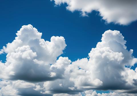 Vast expanse of bright blue atmosphere dominated by large puffy white weather clouds