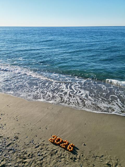 Oranges, New Year's decorations on the beach. Christmas by the sea