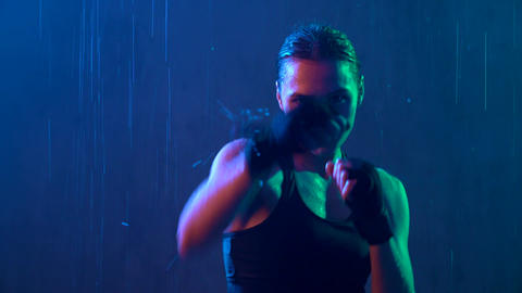 Wet woman doing hit boxing workout