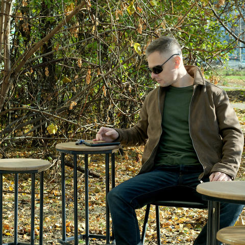 Relaxed moment in nature with thoughtful man enjoying the outdoors in fall