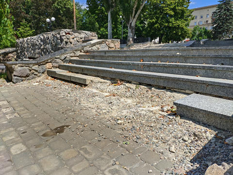 Steps of an old stone staircase are collapsing, crumbling