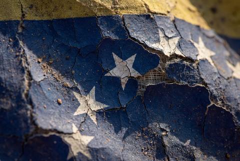 Weathered texture of cracked and peeling european union flag symbol on rough surface