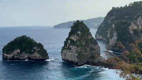 Secluded coastal panorama, uninhabited rocky promontory with dynamic ocean activity and