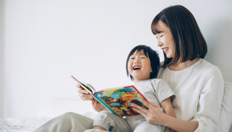 読み聞かせで笑い合う日本人親子(母と子)